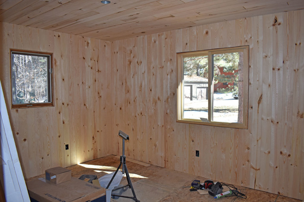 Knotty pine installed on walls and ceiling in bedroom 1.