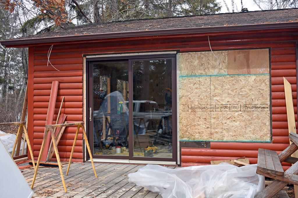 The old window is sealed up and the new sliding glass doors are installed.